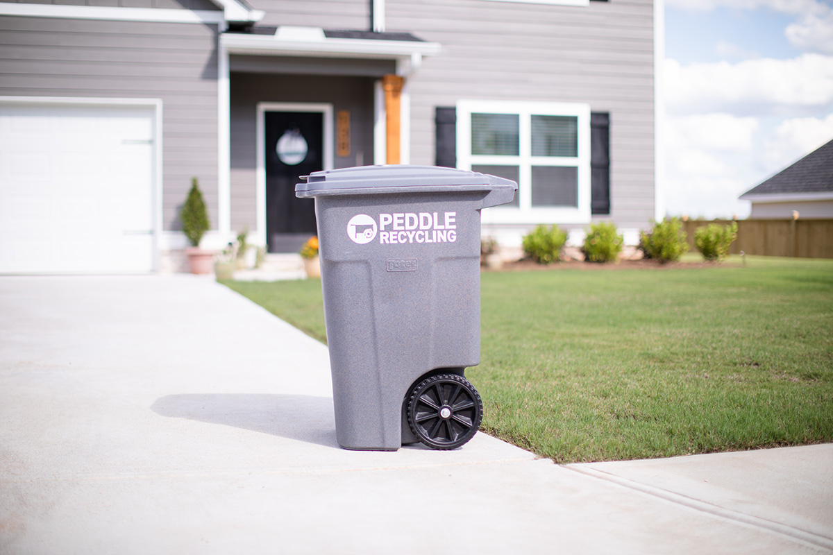 Peddle Recycling can in front of a house